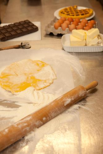 an egg and cheese on a table with a knife at Hotel Mini Palace - Country House in Molinella