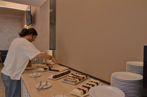 a woman standing in a kitchen preparing cupcakes at Hotel Opal in Jupiter