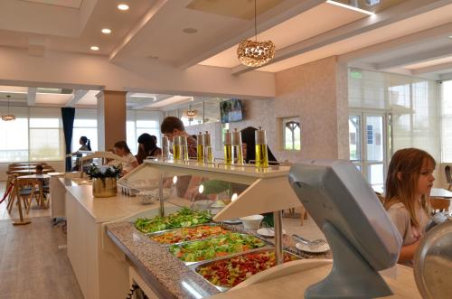 a restaurant with a buffet with many plates of food at Hotel Opal in Jupiter