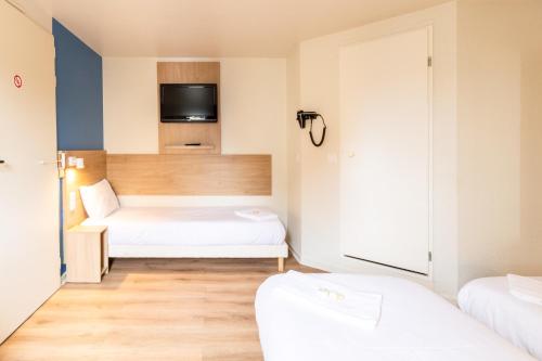 a small room with two beds and a tv at BRIT Hotel Rouen Nord - Barentin in Barentin