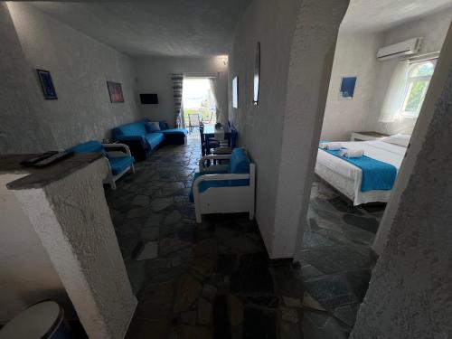 a hotel room with two beds and a living room at Phoenix Beachside Condos in Kokóni