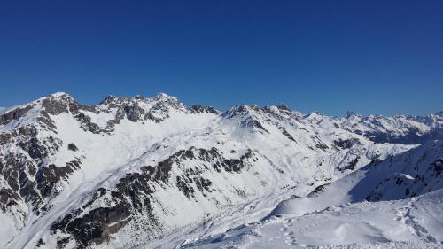 a mountain covered in snow with a blue sky at Appartement Habicher in Pettneu am Arlberg