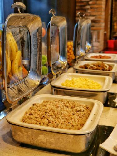 a buffet with several trays of food on a table at Rosana Hotel in Seoul