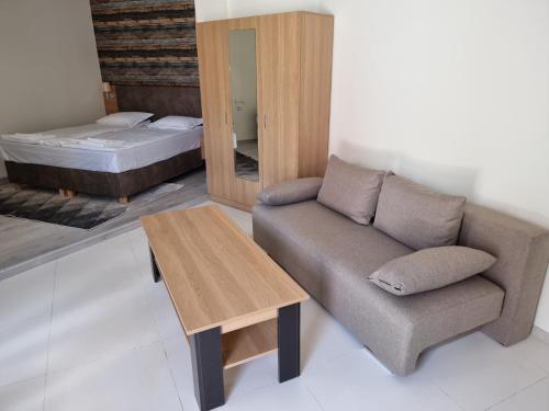 a living room with a couch and a bed at Бутикови Студиа БРИТА in Kranevo