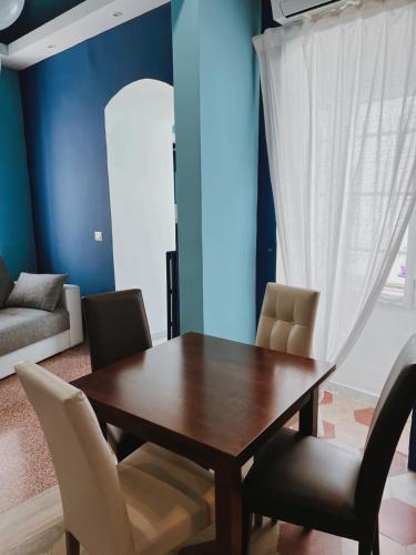 a dining room with a wooden table and chairs at DEAS B&B in Trani