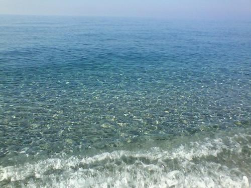 a large body of water with rocks in it at Stella d'Aurora waterview in Belmonte Calabro