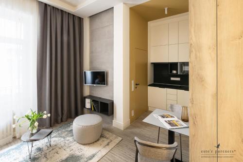 uma pequena sala de estar com mesa e cadeiras em White Boat Studio Apartment GOLD em Budapeste