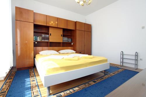 a bedroom with a large bed with a wooden headboard at Your Rooms in Portoroz TM in Portorož