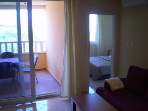 a living room with a bed and a balcony at Apartments Tare, Electric Car Refill in Vodice