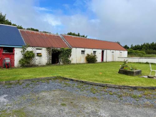 an old white building with a red roof at Kerry Country House in Kilteean