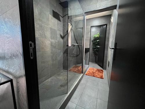 a bathroom with a shower with a glass door at Blue Point in Costa da Caparica