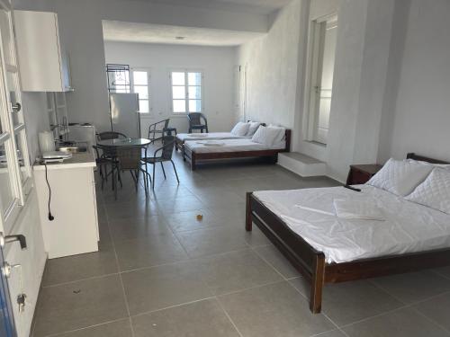 a living room with two beds and a table at Panorama of seladi in Kastron