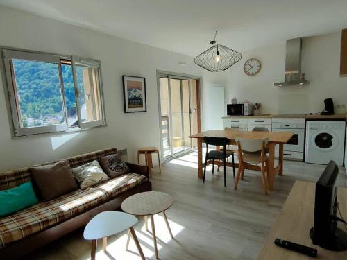 un salon avec un canapé et une table dans l'établissement Appartement rénové 4 pers avec parking à Cauterets - FR-1-234-242, à Cauterets