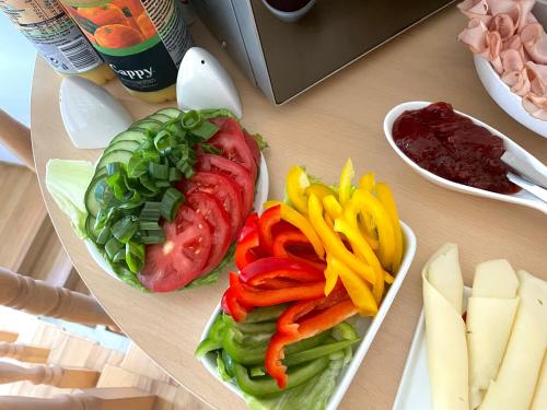 a table with a sandwich with peppers and other vegetables at Hostel Wilanów in Warsaw