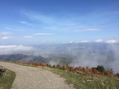 a dirt road on a hill with clouds in the distance at Stella d'Aurora waterview in Belmonte Calabro