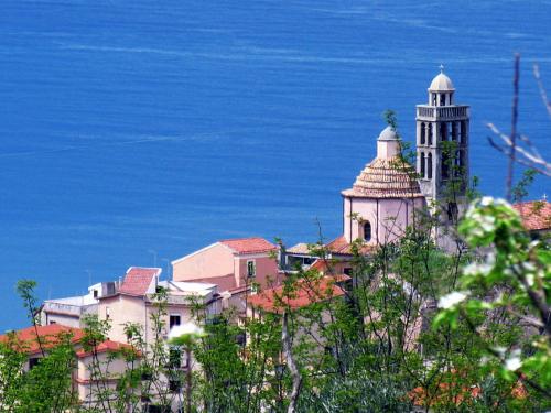 a building with a clock tower on top of it at Stella d'Aurora waterview in Belmonte Calabro