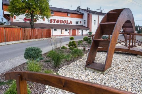 a wooden bench sitting on the side of a street at Třebovický mlýn in Ostrava