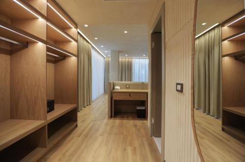 a hallway with a desk and a sink in a room at Elite Bay Hotel Lalez Durres in Lalëz