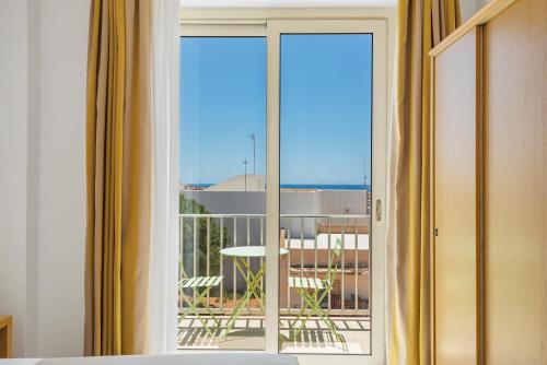 a sliding glass door with a view of a balcony at Hotel Vega in Lampedusa