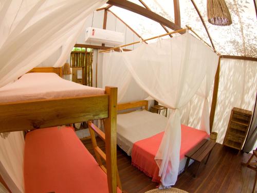 a bedroom with two bunk beds in a tent at Glamping Algodões in Marau
