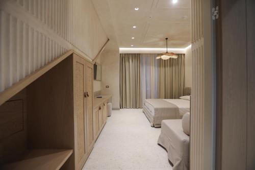 a hotel room with two beds and a staircase at Elite Bay Hotel Lalez Durres in Lalëz