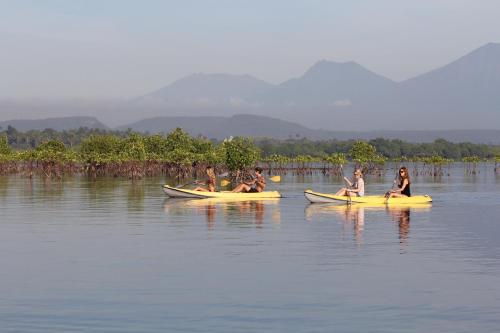 a group of people sitting on kayaks in the water at Sumberkima Hill 2 in Pemuteran