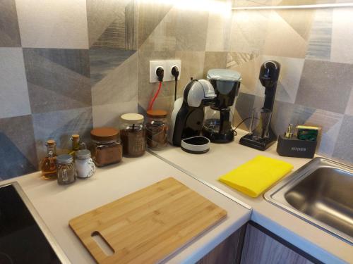 a kitchen counter with a cutting board next to a sink at Lefis House in Volos
