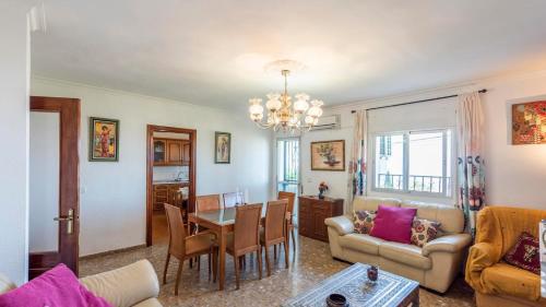 a living room with a table and a dining room at Casa Los Naranjos Canillas de Aceituno by Ruralidays in Canillas de Aceituno