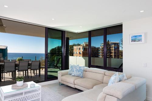 a living room with a couch and a table at The Strand 602 in Forster