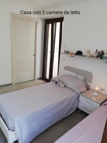 a bedroom with a bed and a window at Fascino del Cilento in Caprioli
