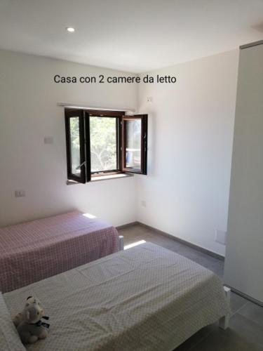 a room with two beds and a teddy bear in it at Fascino del Cilento in Caprioli