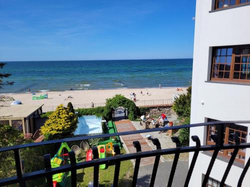 a view of the beach from the balcony of a building at Dom Przy Plaży in Sarbinowo