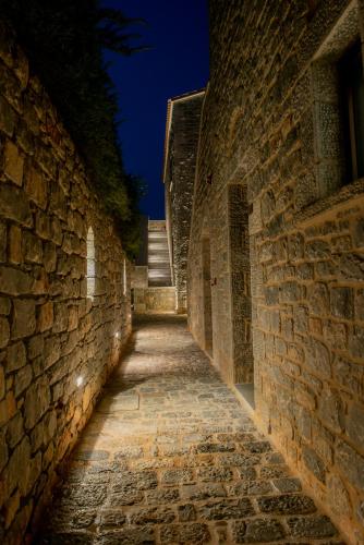 an alley in an old stone building at night at Manifest Boutique Hotel in Oítilon