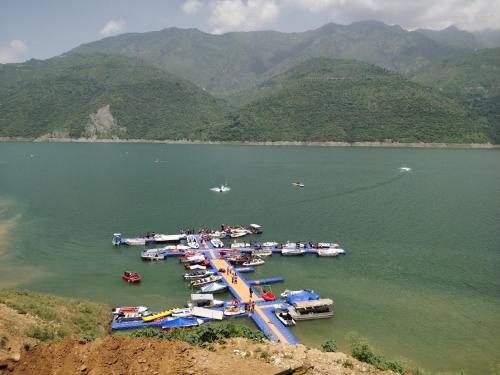 a group of boats in a large body of water at The Bugyal in Kanatal