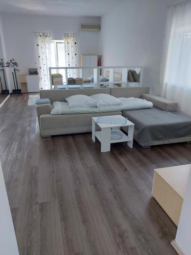 a bedroom with a large bed and a table at Vita Style in Kaštela
