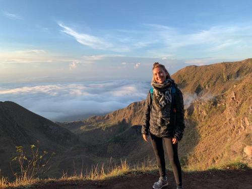 a woman standing on top of a mountain at Triangle House and hot spring in Kintamani