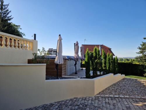 a villa with a courtyard with umbrellas and trees at la source de bougival in Bougival