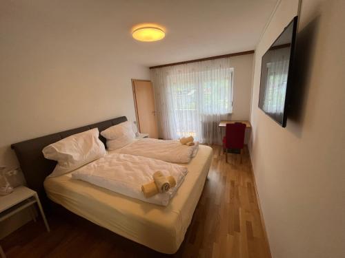 a bedroom with a bed with a teddy bear on it at Apartementhaus Helene am Klopeinersee in Unterburg am Klopeiner See