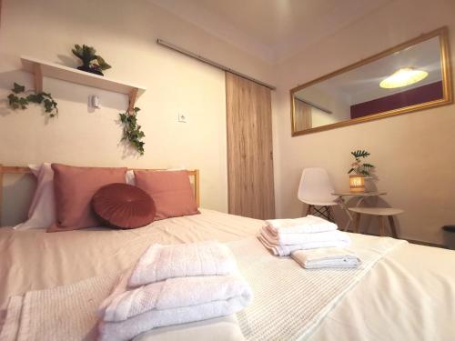 a bedroom with a bed with towels on it at Seaside BLISS in Agia Triada