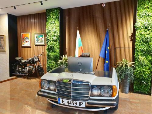 an office with a car with a laptop on top of it at Spa Hotel Spartak in Sandanski