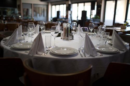 a table with wine glasses and napkins on it at Spa Hotel Spartak in Sandanski