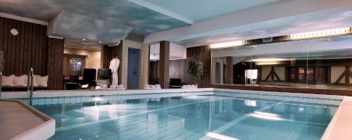 a large swimming pool in a hotel room at Hotel Kathrin in Grossarl