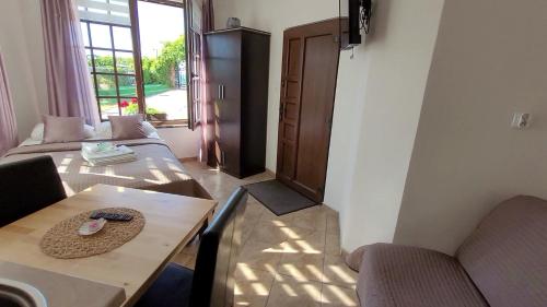 a living room with a couch and a table at Dom Przy Plaży in Sarbinowo