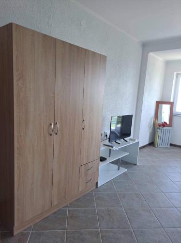 a large wooden cabinet in a room with a television at Villa&Restaurant Strmec in Elshani