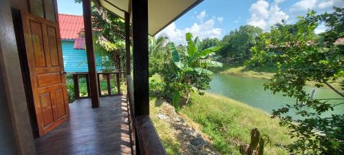 an open door to a room with a view of a river at Mind House Bungalow in Nam Theun