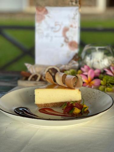 a piece of cheesecake on a plate on a table at Murex Dive Resort in Manado