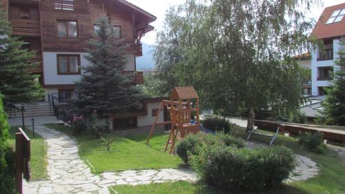 a playground in the yard of a house at St Ivan Rilski Spa Luxury apartment Bansko & Free SPA in Bansko