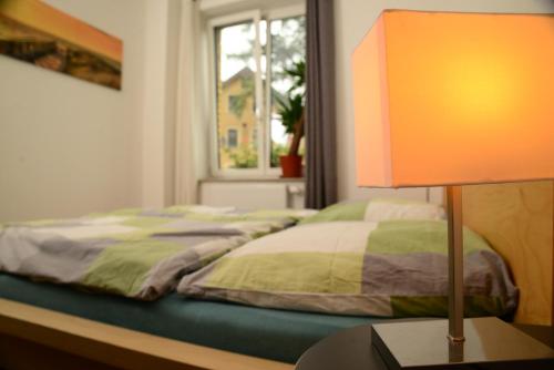 a bedroom with a bed and a table with a lamp at Ferienanlage Markus Nitsch in Bärenstein