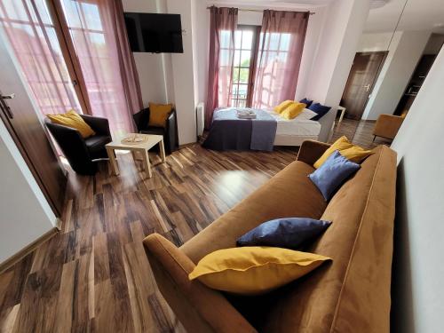 a living room with a couch and a bed at Dom Przy Plaży in Sarbinowo