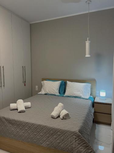 a bedroom with a bed with two towels on it at SEA HORIZON SUITES in Chalkida